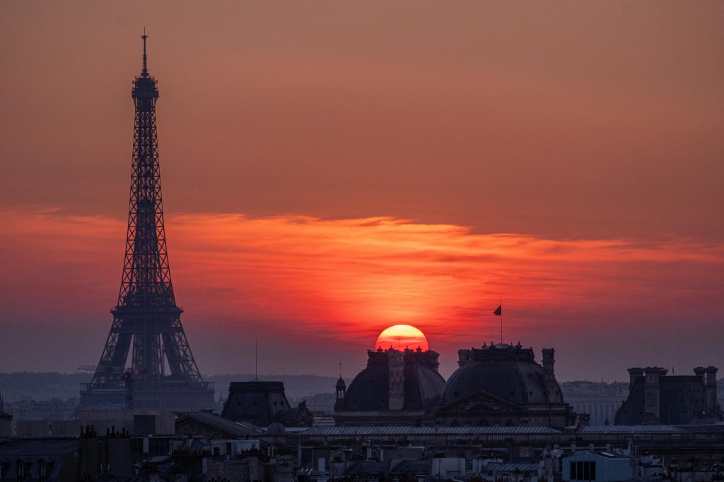 Experience the breathtaking sunset over Paris with the iconic Eiffel Tower silhouette.