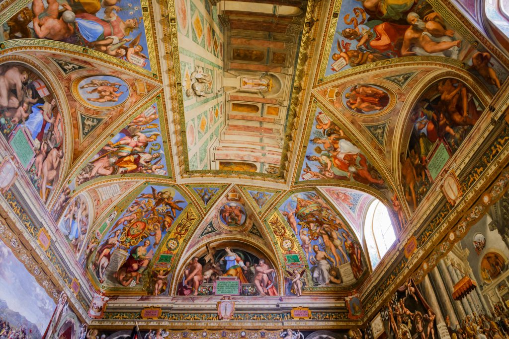 Intricate frescoes adorning the arched ceiling of a historic Roman chapel.
