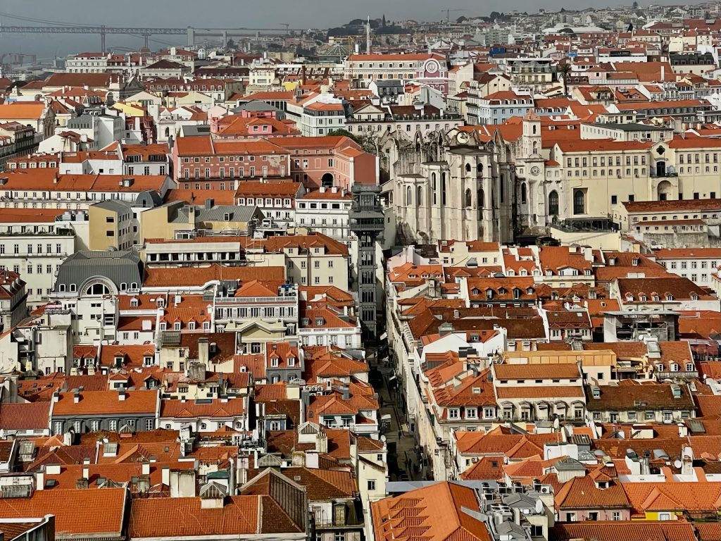A breathtaking aerial view of Lisbon showcasing its iconic red rooftops and historic architecture.